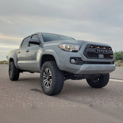 Gray Toyota truck on a road with a desert landscape in the background