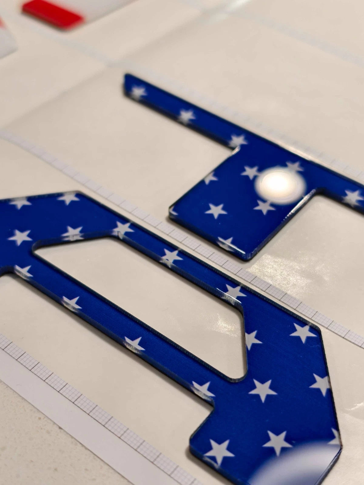 Two blue license plate frames with white star patterns 